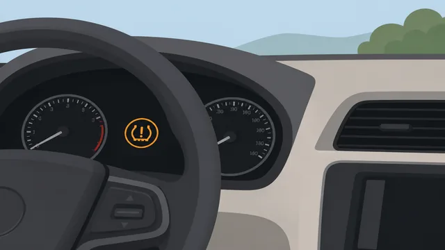 Car dashboard displaying a tire pressure monitoring system warning light
